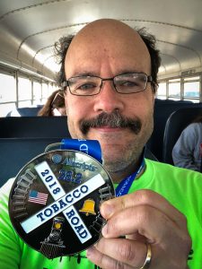 Carlos Candelaria with Tobacco Road Marathon Medal