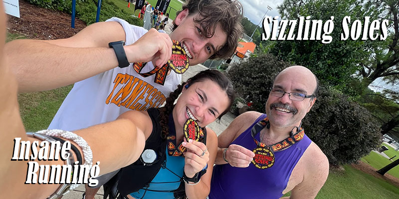 Sizzling Sole Half marathon runners showing off their medals